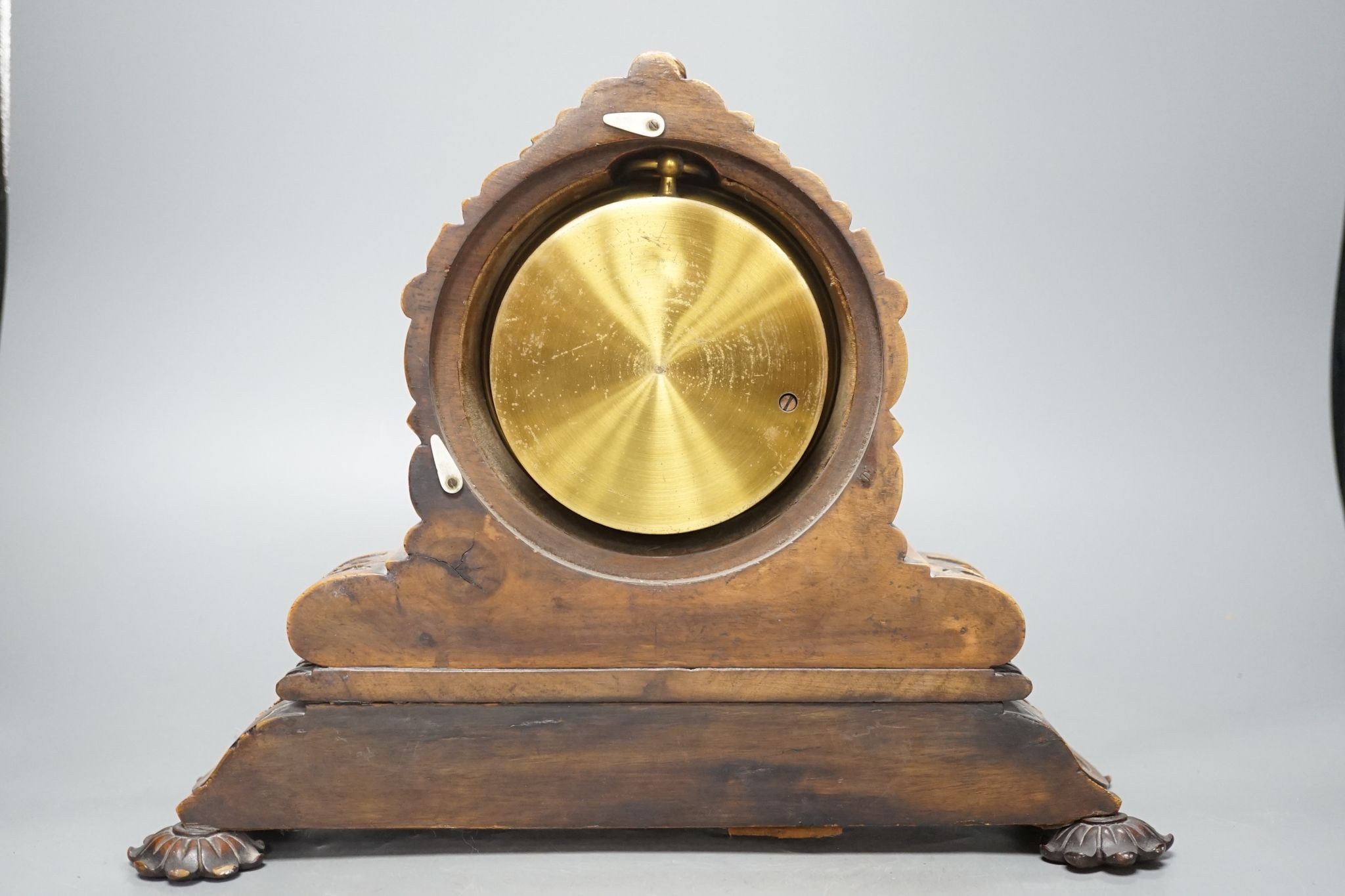 A late Victorian carved walnut aneroid mantel barometer by Negretti and Zambra, 34 cms wide